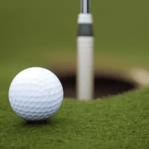a golf ball near its hole