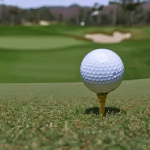 a golf ball on its yellow tee