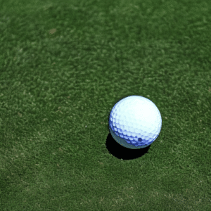 a golf ball on the artificial grass