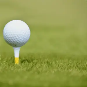 a golf ball on yellow tee