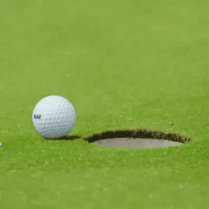 a golf ball with a symbol near hole
