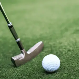 golfer taking a stance to hit the ball using a wedge