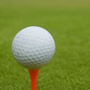 a golf ball on a red tee