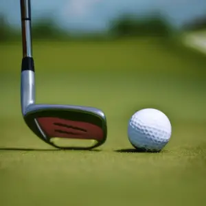 a golf club hitting a ball