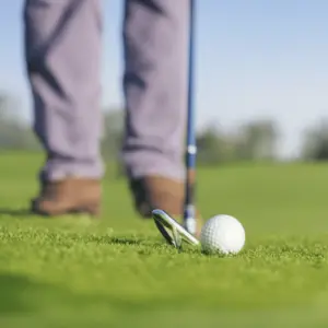 a golfer taking a stance to hit the ball