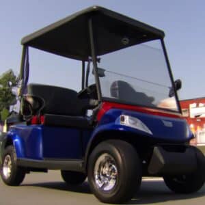 A golf cart parked on the side of a road