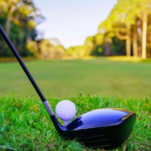 a black big clubhead and a golf ball