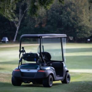 a black golf cart in a golf course