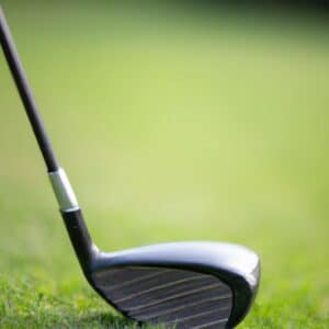 a black golf club on a grassy surface