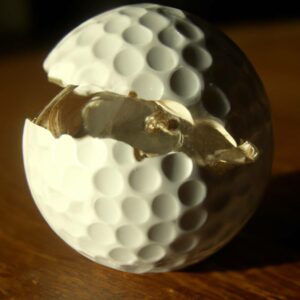 a damaged golf ball on the table