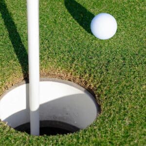 a golf ball close to a golf hole