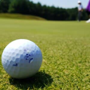 a golf ball with a crack on the grass