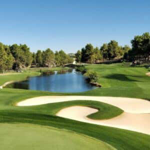 a golf course with bunker and lake