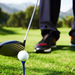 a golfer taking a stance before swinging his club