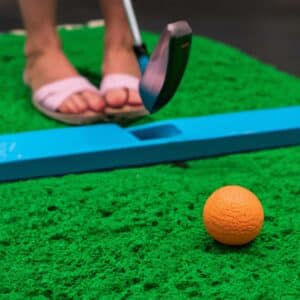 orange golf ball on mini golf course