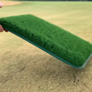 putting a golf mat on the course