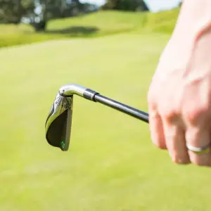 Close up image of a golfer holding an Adjustable Loft Golf Club