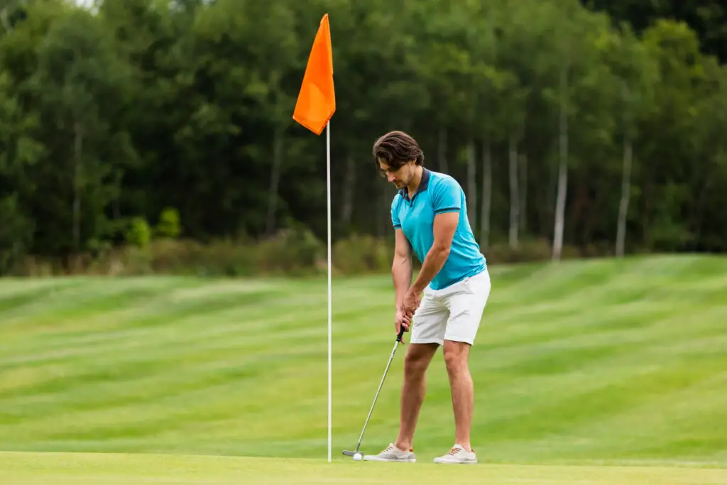 adult man playing golf