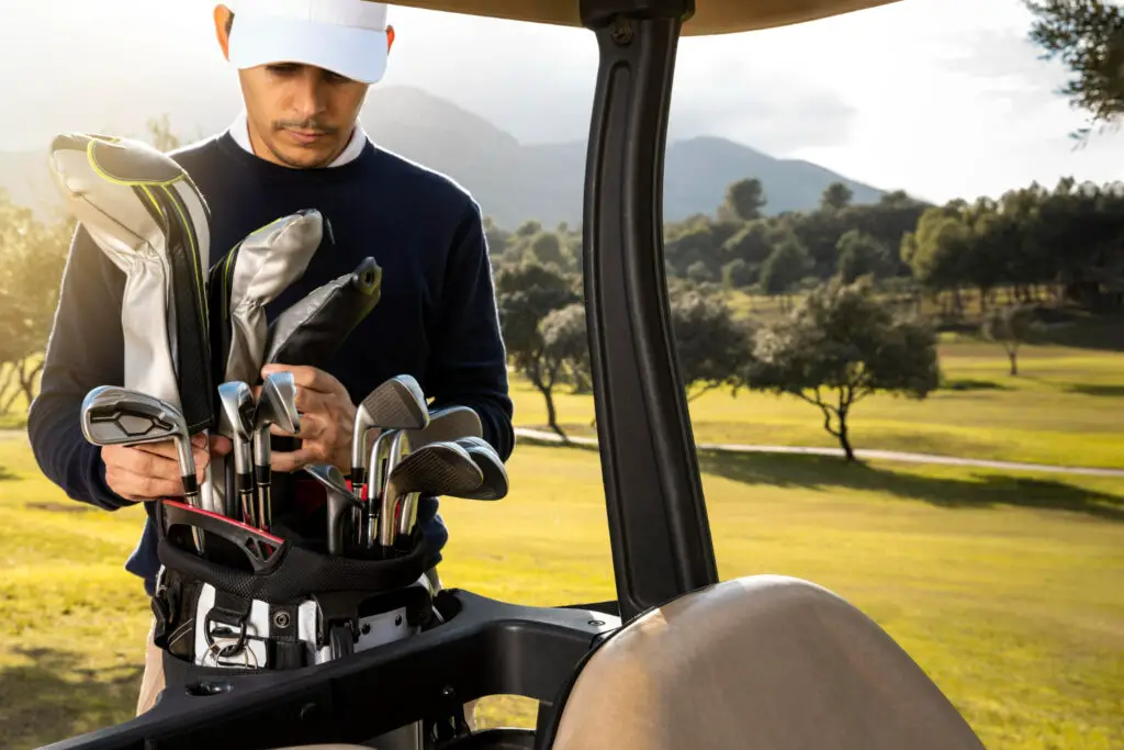 front view man putting clubs golf cart 1