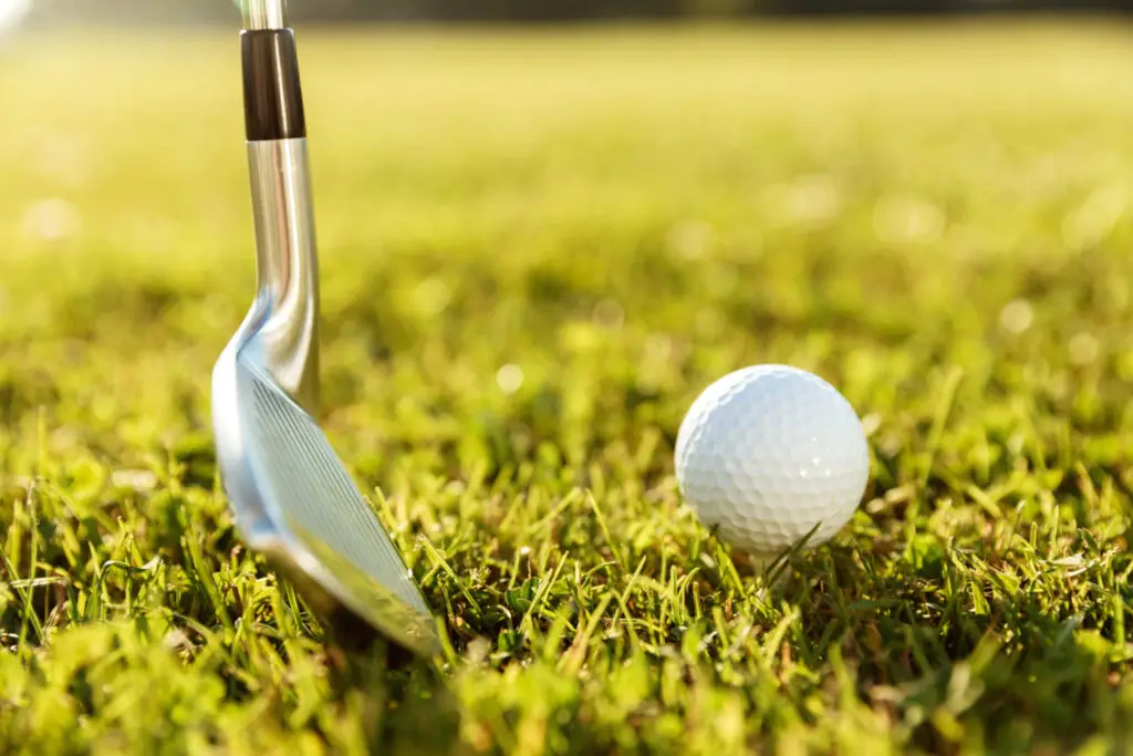 golf club ball green grass