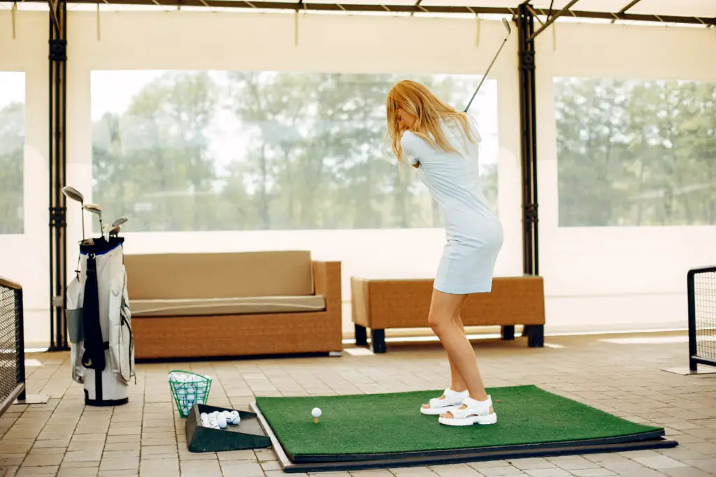 a girl playing golf indoor