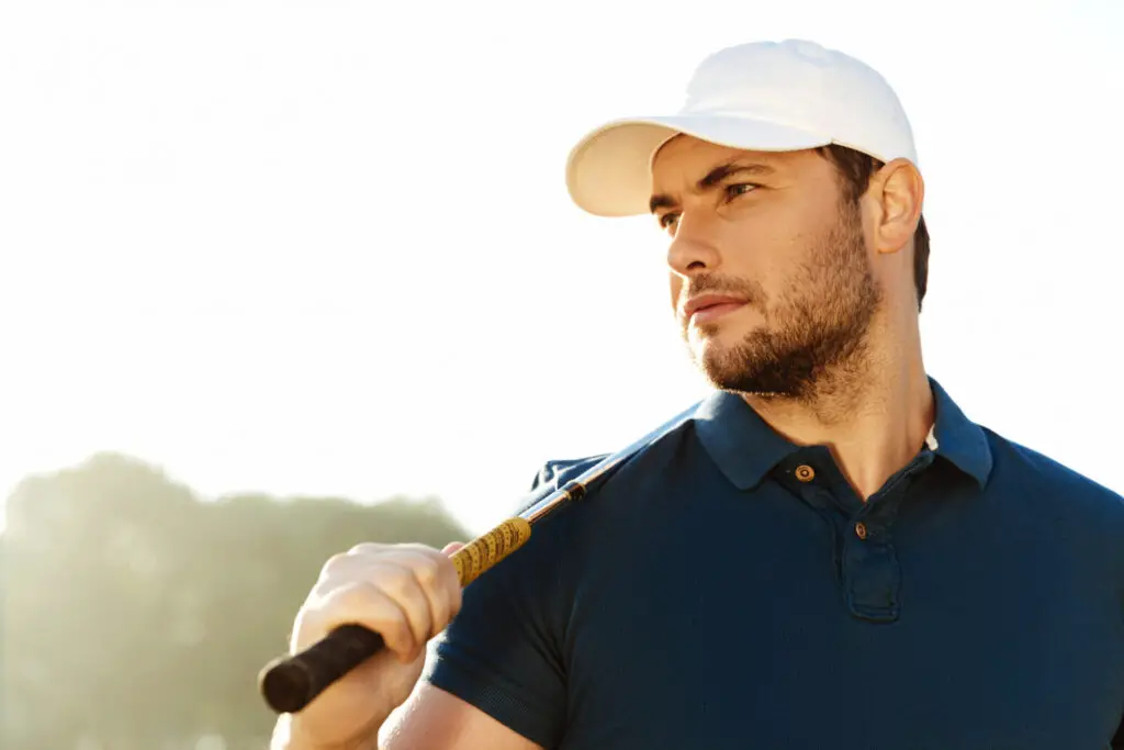 a man holding golf club