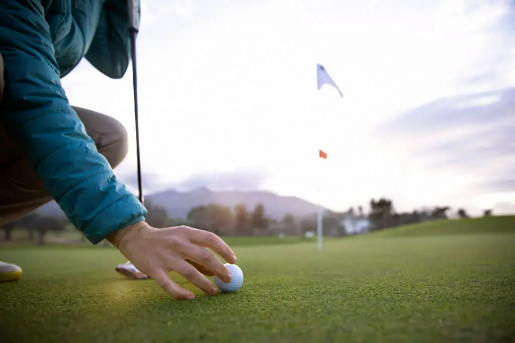 a person aiming golf flag 1