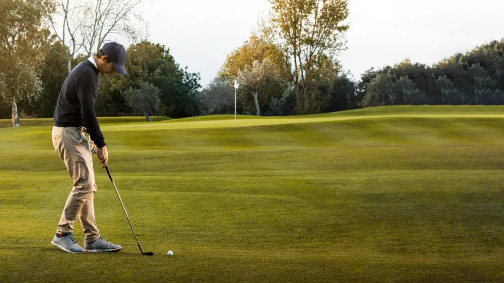 a side view of man playing golf