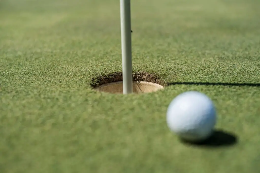 golf field with white ball near hole