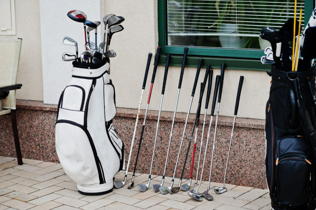 many golf clubs and bag pavement